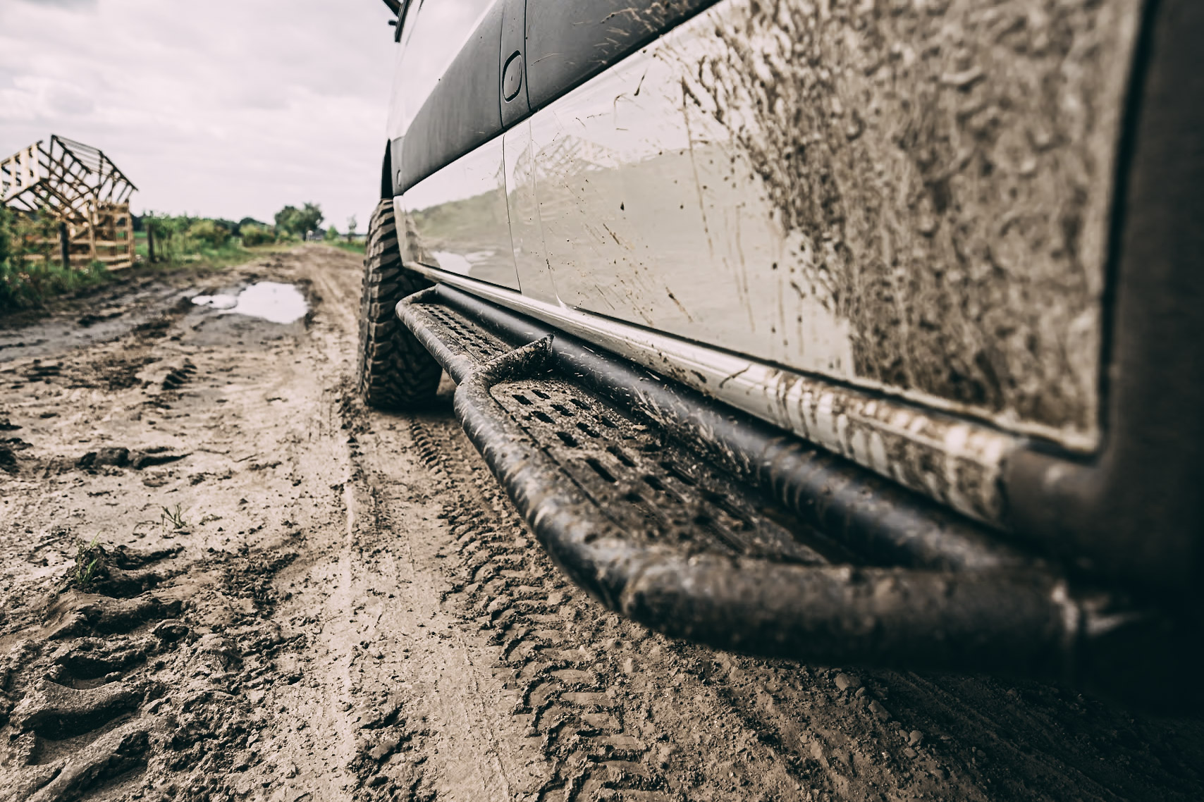 Sequoia Side Steps Mercedes Sprinter covered in mud.